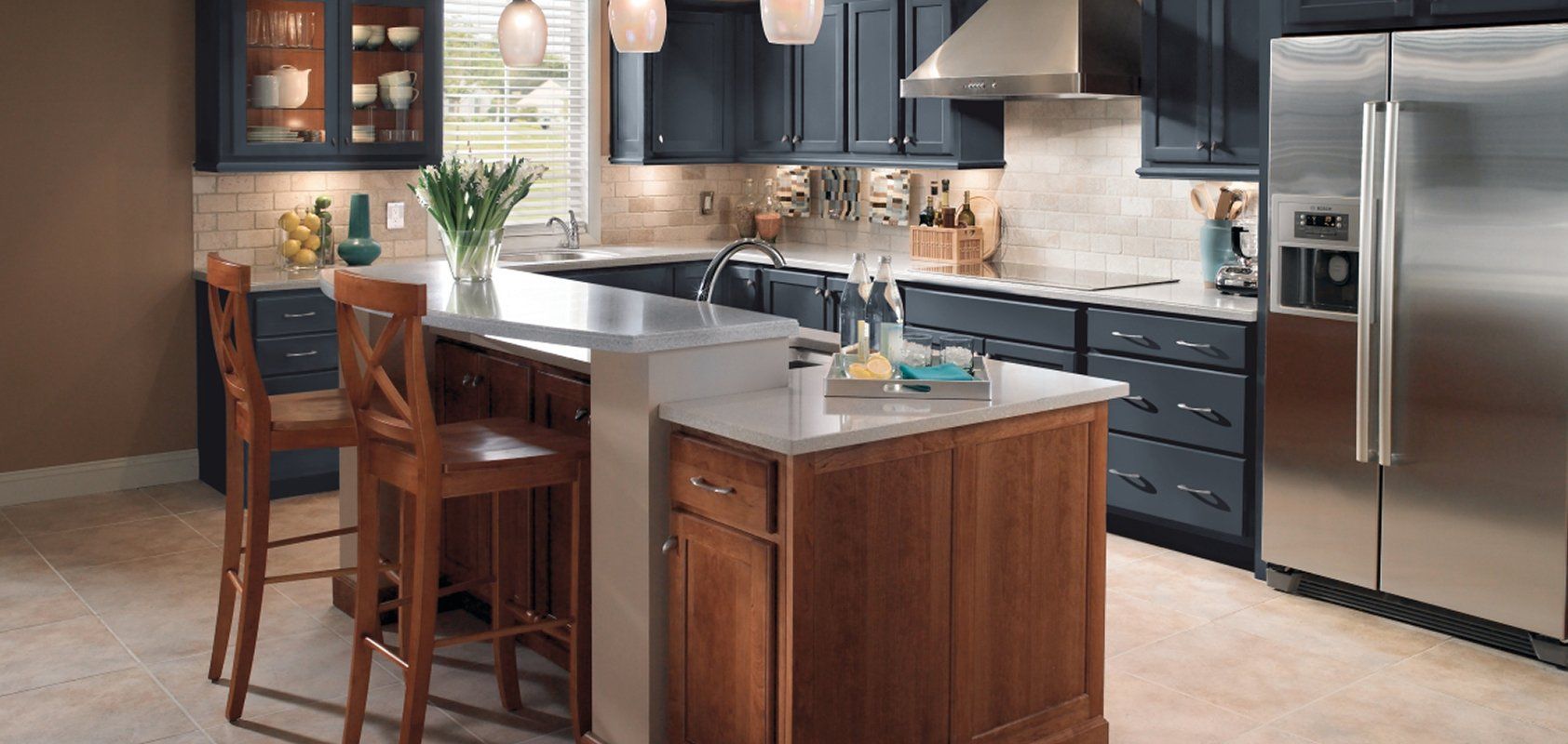 Navy cabinetry and a cherry island in a finished kitchen
