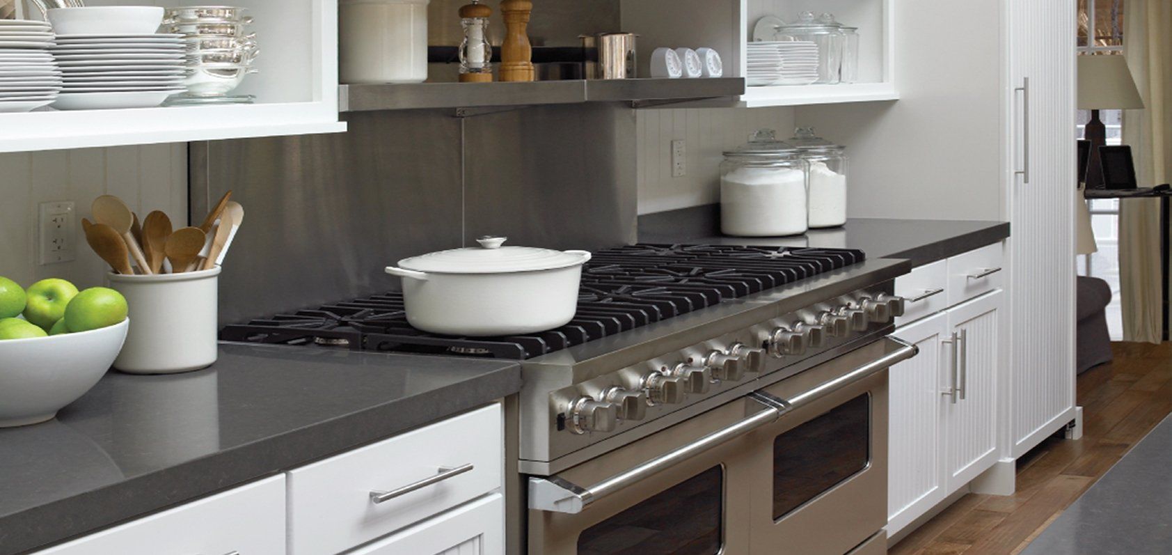Dark quartz countertops running alongside a professional range