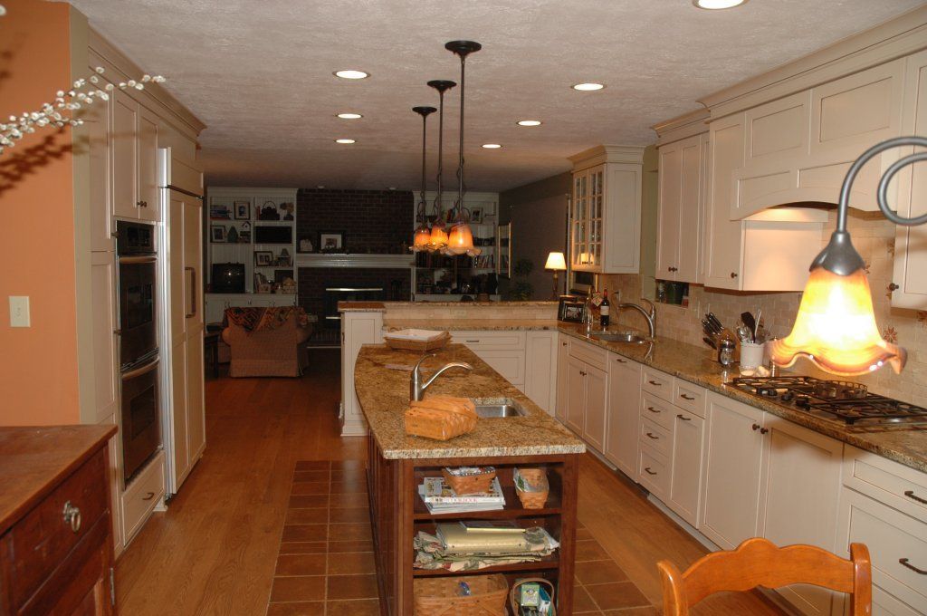 Completed Pioneer Kitchens remodel with cream cabinetry, a granite island and tile flooring