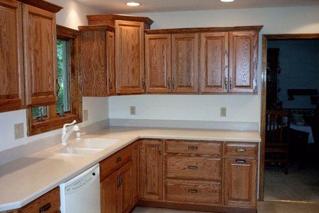 Solid oak kitchen cabinetry with a light countertop